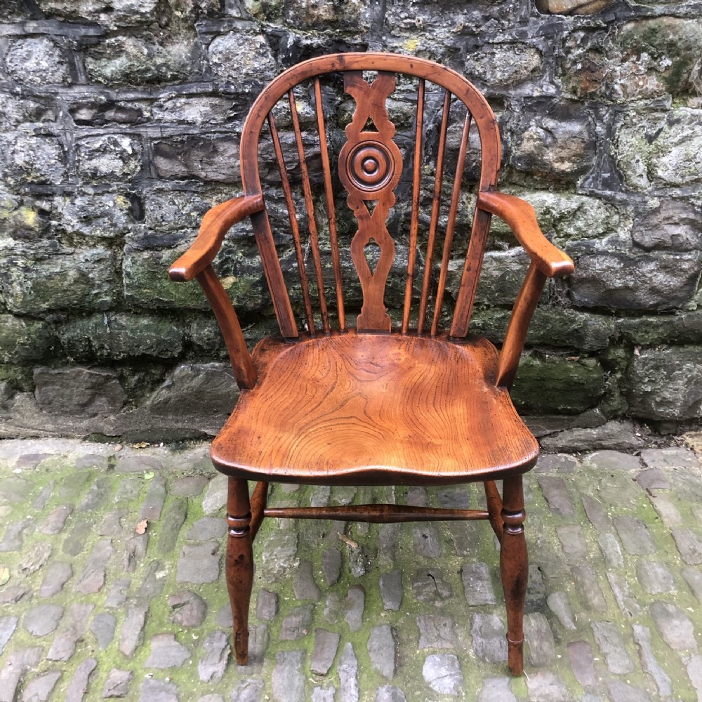 An Early 19th Century Yew and Elm Draught Back Windsor Chair