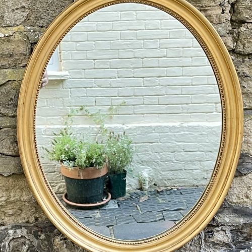 A Mid Victorian Oval Giltwood Mirror